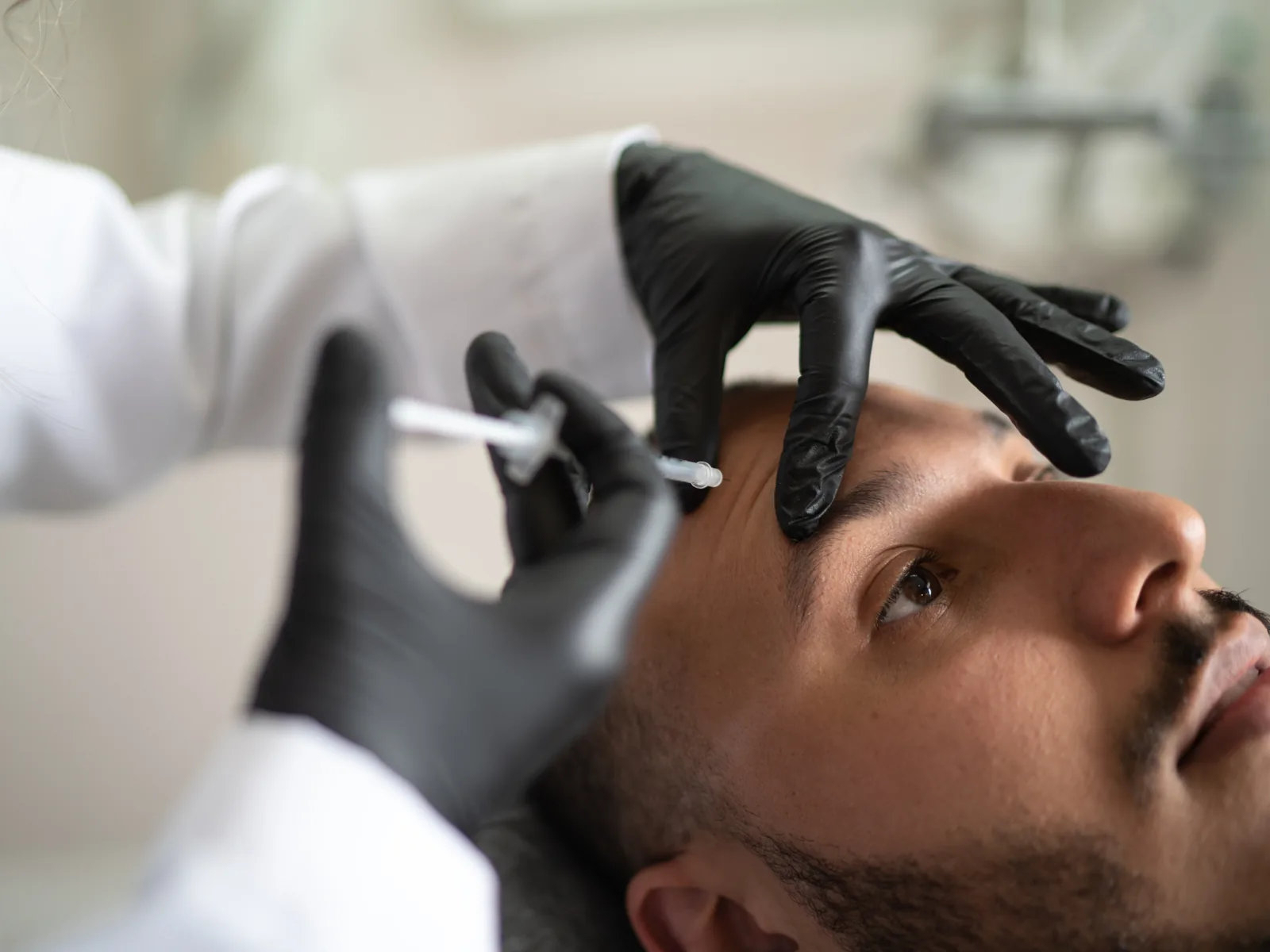 Masculine facial contouring being performed at Charis Aesthetics
